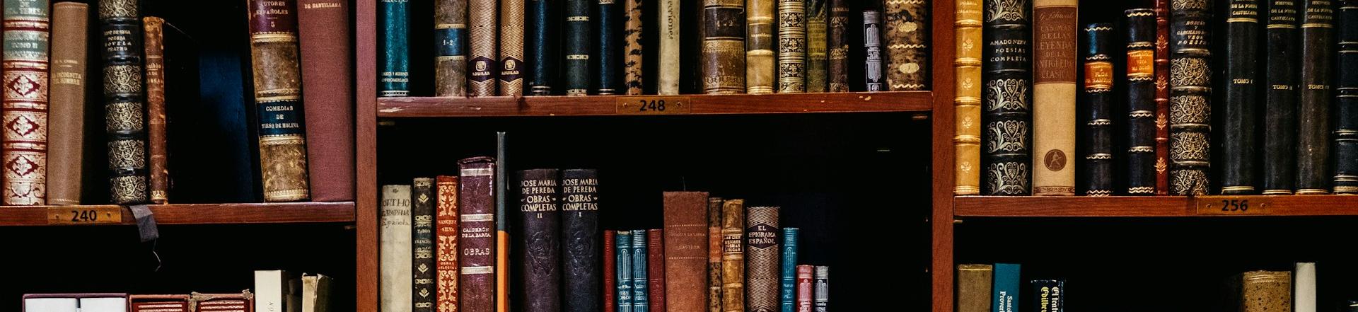 assorted-title of books piled in the shelves